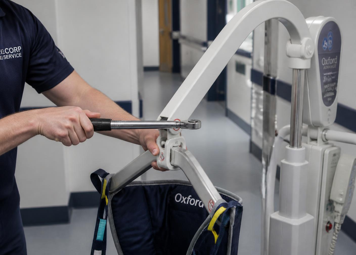 Technician carrying out functional checks on a patient hoist and sling